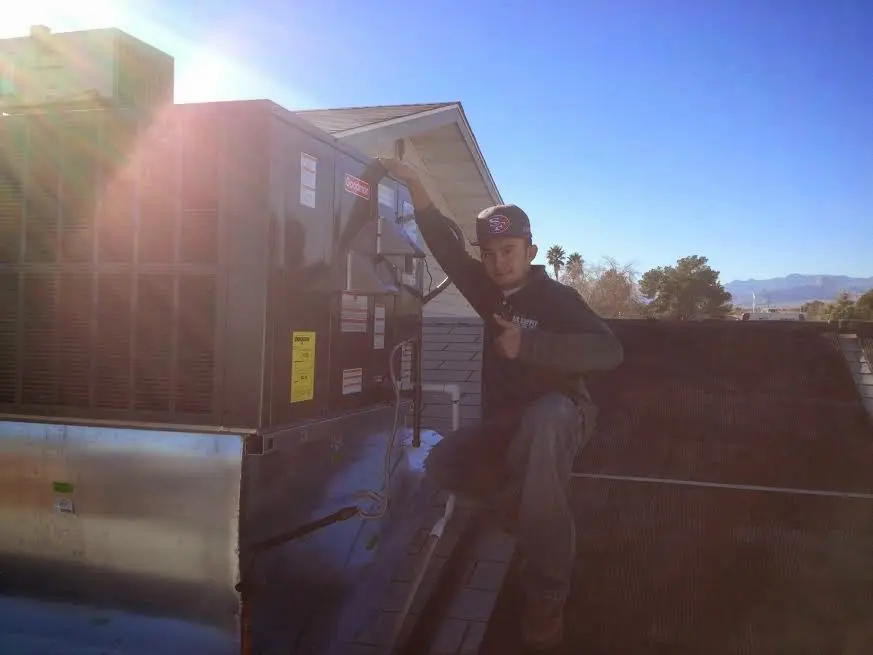 HVAC technician performing Air Duct Repair on a rooftop unit in Pocono